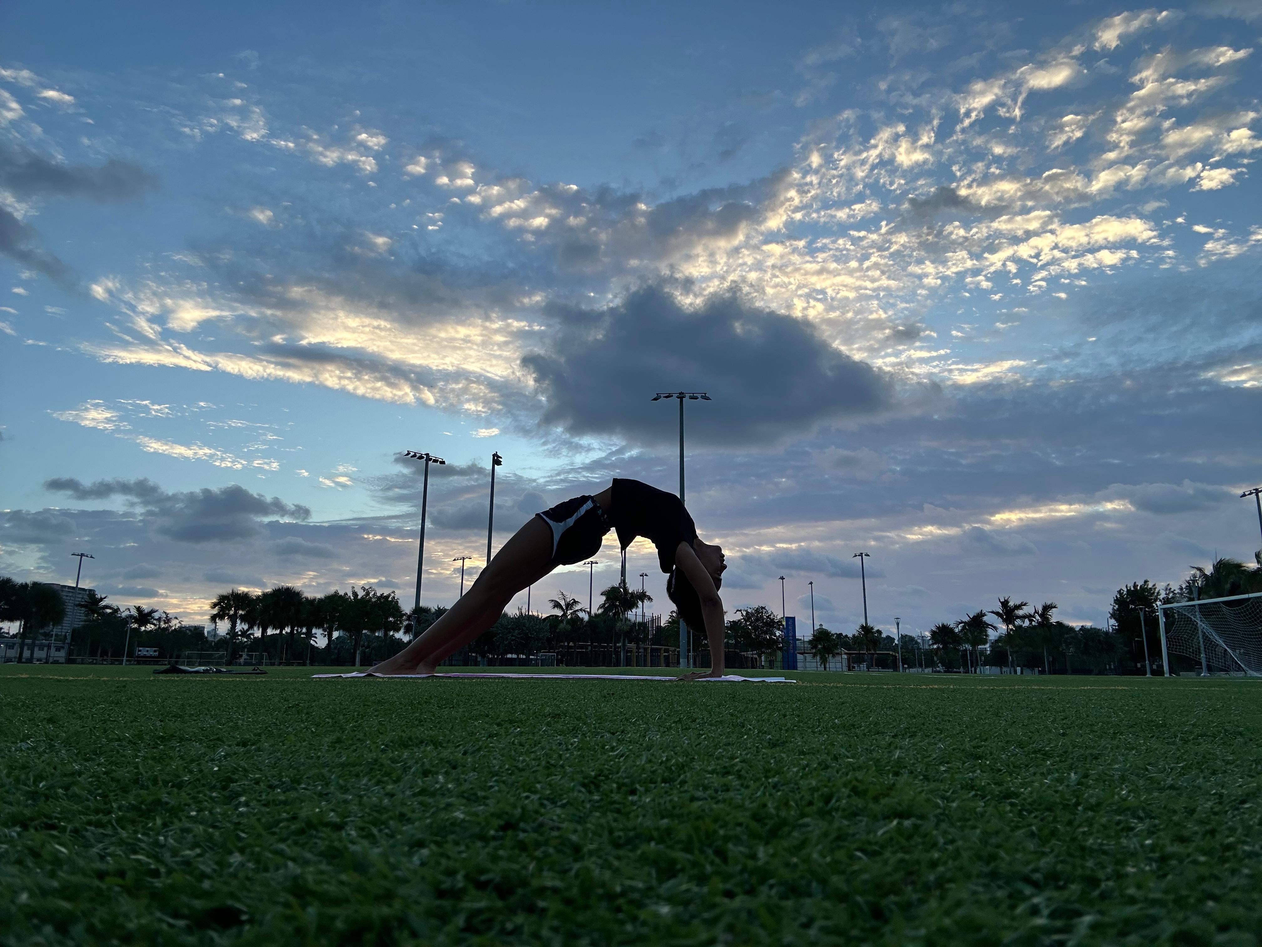 Amanda in wheel pose at sunset
